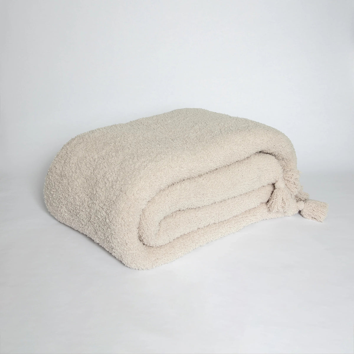 Jeté étendu à imprimé double épaisseur uni beige rougissant avec pompons