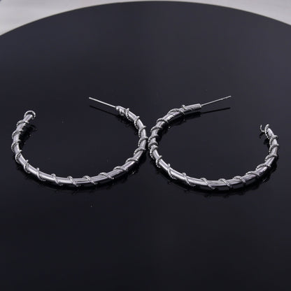 ELNA Silver Hoop Earrings with a Decorative Twist