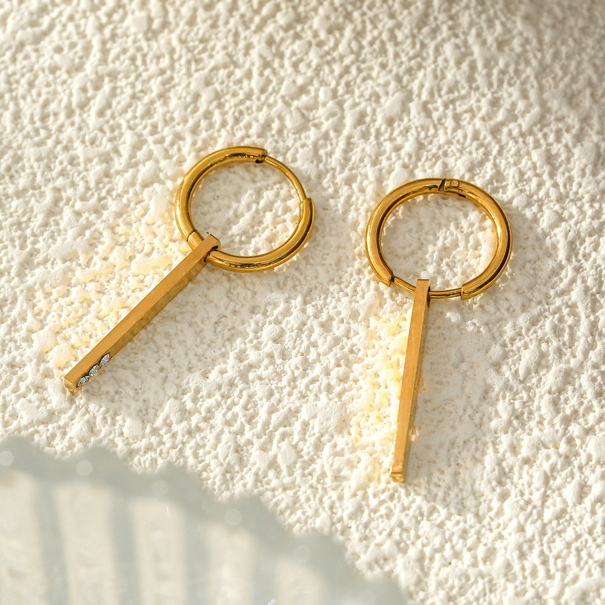 Style MAYLA: Gold Hoops with a Minimalist Charm featuring a Trio of Zirconia Gemstones